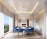 Dining space featuring a chandelier, a warm lit fireplace, a raised ceiling, and light wood-style floors