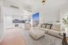 Living area with light wood finished floors and recessed lighting