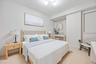 Bedroom with light wood finished floors and baseboards