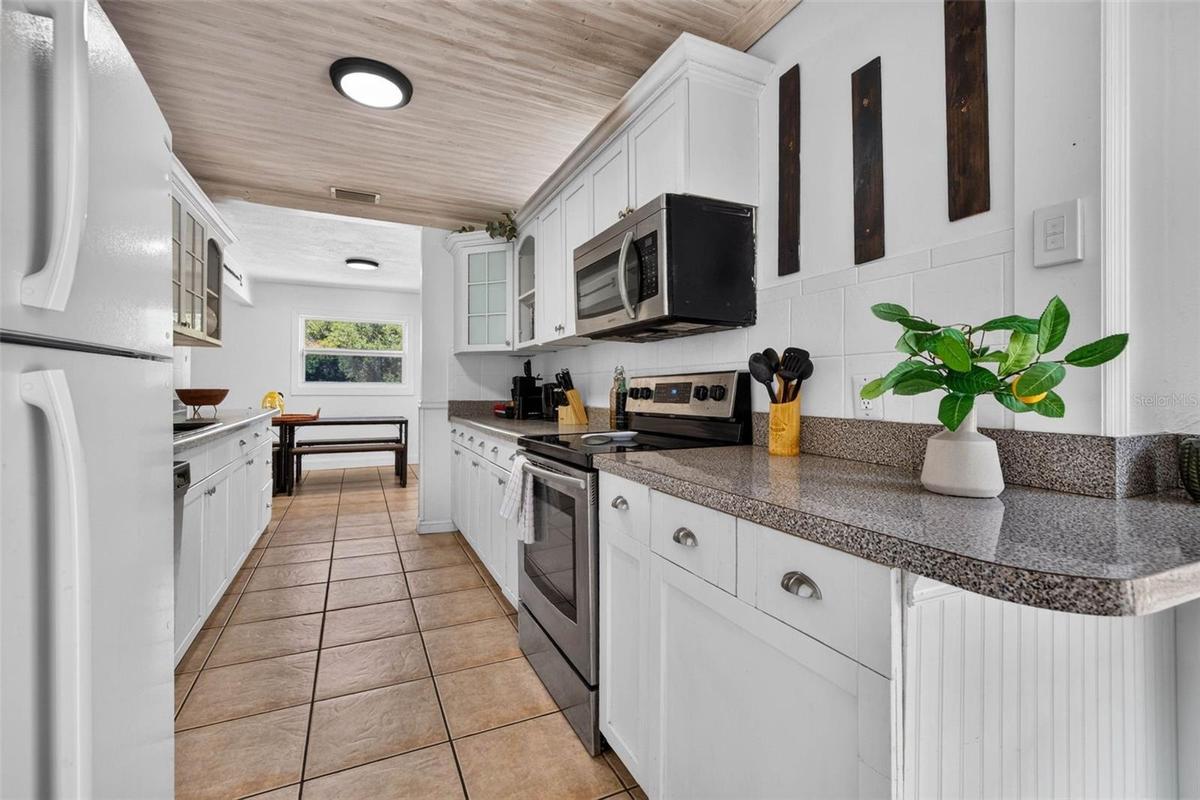 All white cabinets and decorative ceiling.