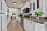 All white cabinets and decorative ceiling.