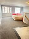 Bedroom with lofted ceiling, recessed lighting, and light colored carpet