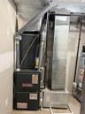 Utility room featuring heating unit and water heater