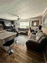 Wood-finish flooring throughout, complemented by an overhead ceiling fan