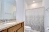 Additional full bath providing flexibility for family and visitors.