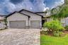 Oversized garage with carpeted flooring and exceptional versatility.