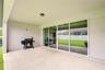 Covered outdoor living space overlooking the backyard.