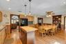 Kitchen featuring wood-finish flooring, recessed lighting, and a dark wood island with a butcher block countertop
