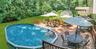 Expansive rear deck featuring a  pool with steps