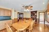 Dining area featuring wood-finish flooring and a ceiling fan with light fixture