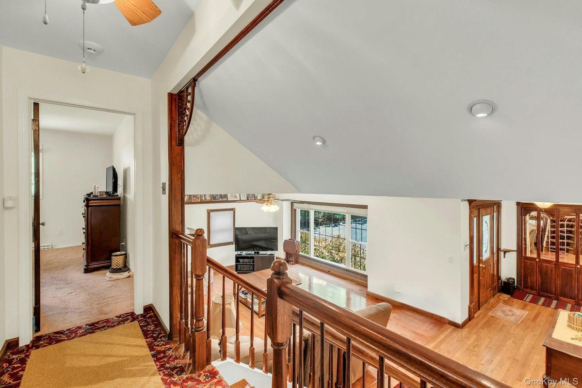 Staircase with wood railing and balusters