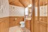 Bathroom featuring a paneled wood ceiling and wainscoting