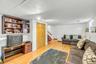 Finished living space featuring wood-finish flooring, white walls, and a drop ceiling with recessed lighting