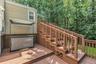 Multi-level wood deck featuring stained wood planking and railings