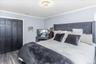 Bedroom featuring wood-finish flooring, crown molding, and a contemporary ceiling light fixture