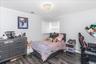 Room featuring wood-finish flooring, white walls, and crown molding