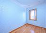 Hardwood flooring throughout featuring decorative wall finish and crown molding