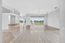 From Entryway to Living Room, Bar Area, Breakfast Area with Aquarium Window and Family Room with Large Sliding Glass Doors to Covered Lanai off Living
