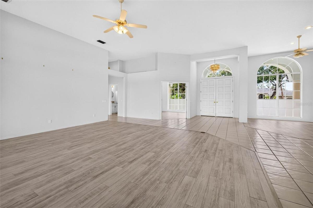 Large Living Room with view of Dining Room, Entryway, Den/4th Bedroom and Half Bath for Guests and 4th Bedroom