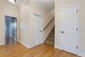 Looking towards Stairs, Garage Door and Coat Closet
