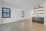 right dining space positioned beside kitchen and living room featuring wet bar and large glass sliders, offering great natural light and easy access t