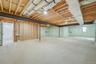 Full basement with high ceilings and outside entrance, offering excellent potential for future finished space or storage.