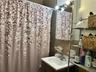 Bathroom featuring a shower with shower curtain, vanity, and tile walls
