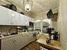 Kitchen with light countertops, white gas range, ornamental molding, dark wood-style flooring, and stainless steel microwave