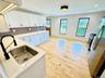 Stainless appliances; quartz countertops; tasteful backsplash.