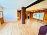 This is off the kitchen. Gleaming floors, lots of windows here.