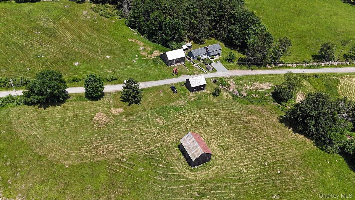 House on right of pic; showing all 3 barns as well and the land layout