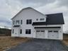 Side view featuring the two car garage, timeless Colonial styling enhanced by modern finished.