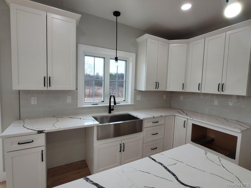 Anchoring this kitchen is an oversized center island that combines elegant, timeless, design with everyday functionality, creating a welcoming space f