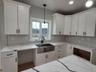 Anchoring this kitchen is an oversized center island that combines elegant, timeless, design with everyday functionality, creating a welcoming space f