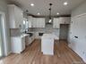 Beautifully appointed kitchen showcasing quality cabinetry, quartz countertops, stainless steel appliances, and generous workspace.