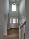 Bright, welcoming foyer offering an impressive introduction with soaring ceilings and an open view into the heart of the home.