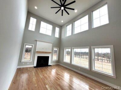 Dramatic great room featuring soaring ceilings and expansive windows that fill the living space with abundant natural light.
