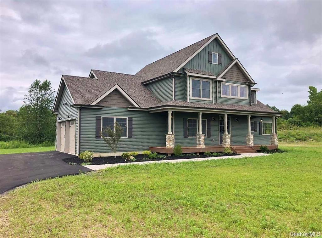 This impressive side view showcases the home’s generous yard, expansive outdoor space, and peaceful wooded surroundings, offering a rare combination o