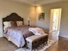 The thoughtfully arranged bedroom offers a comfortable layout with space to unwind at the end of the day.