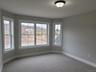 Bedroom 2 features an inviting bay window that fills the room with light and added architectural character.