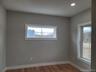 This bright home office has generous windows and a flexible layout to support diverse lifestyles.