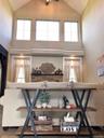 Dramatic two story great room showcases soaring ceilings that create an open, light-filled living space.
