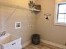 Conveniently located on the lower level, this dedicated laundry room provides a practical and organized space for everyday household tasks while offer