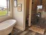 The well appointed bathroom features a soaking tub and separate walk in shower for added comfort.