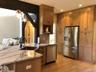 The thoughtfully designed kitchen opens naturally to the home's main living areas, creating an inviting layout that encourages connection and everyday