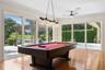 Game area of the GREAT ROOM.  Large Sliding doors to open up the fresh air and always the view of the Lake and natural light