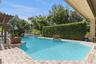 Large hedge provides privacy.  Pool has baja shelf for that tanning in the water
