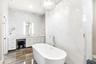 Marble Walls and Ceiling to Counter glass tiled backspace, backglowing mirrors and attached hanging magnifying  mirror.