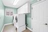 Large indoor laundry with storage - door leads to garage