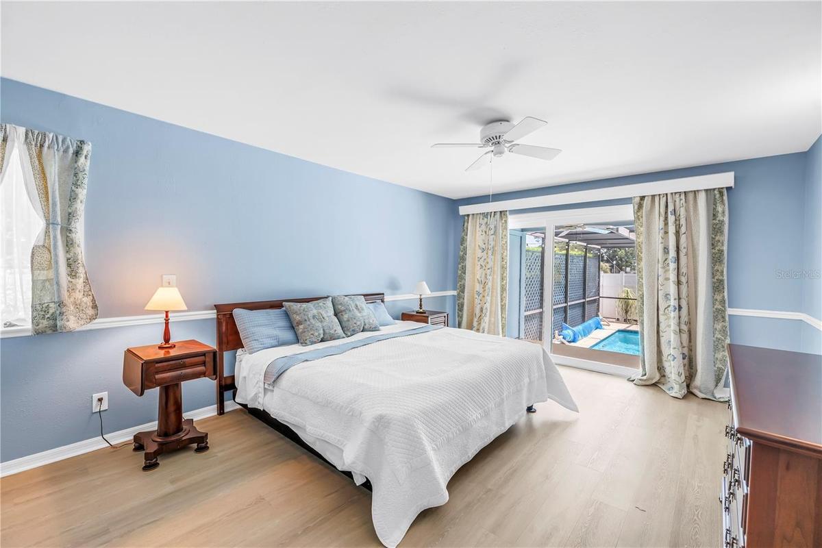 Main bedroom with slider to the pool & patio